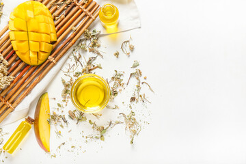 Composition with mango essential oil on light background