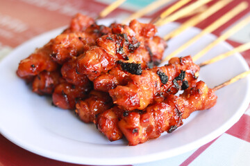 Satay (Indonesian: Sate) is a Indonesian dish of seasoned, skewered and grilled meat, served with a sauce. 