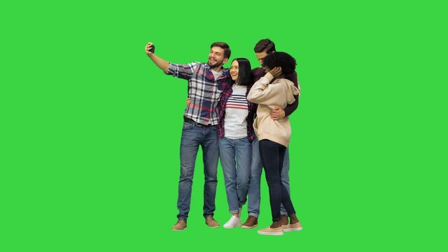 A group of cheerful students taking a selfie on a Green Screen, Chroma Key.