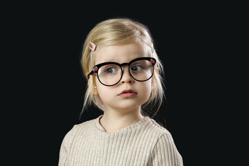 Studio portrait of adorable little toddler girl wearing reading glasses