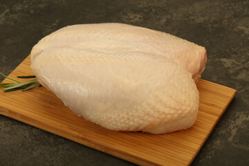 Raw whole chicken breast with skin
