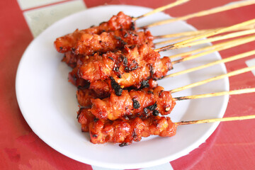Satay (Indonesian: Sate) is a Indonesian dish of seasoned, skewered and grilled meat, served with a sauce. 