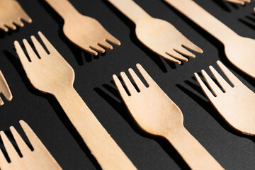 Wooden forks on dark background