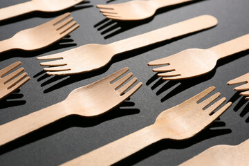 Wooden forks on dark background