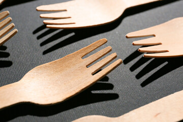 Wooden forks on dark background