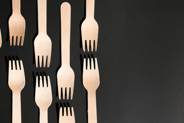 Wooden forks on dark background