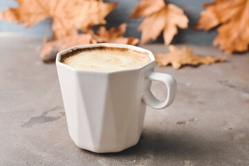 Cup of tasty latte on grunge background