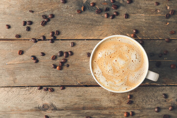 Obraz na płótnie Canvas Cup of tasty latte on wooden background
