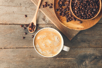 Cup of tasty latte on wooden background
