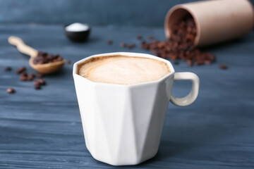 Cup of tasty latte on dark wooden background