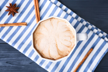 Cup of tasty latte on dark wooden background