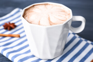 Cup of tasty latte on dark background