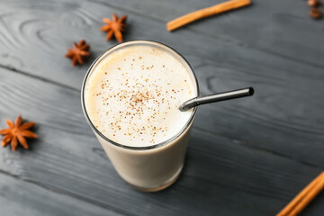 Glass of tasty latte on dark wooden background