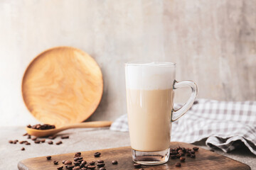 Glass cup of tasty latte on table