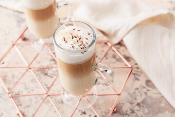 Glass cup of tasty latte on table