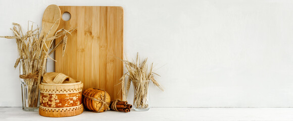 White kitchen banner - oatmeal cookies, bread and ears of grain on a white table. Decorative...