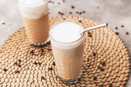 Glasses of tasty latte on table