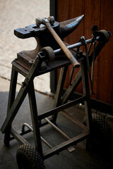 Blacksmith tools. Anvil and sledgehammer in the stable