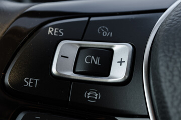 Fototapeta na wymiar Steering wheel details and steering wheel controls. Leather-wrapped Steering wheel. 