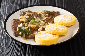 Delicious Fegato alla veneziana recipe a famous and traditional Venetian recipe closeup in the plate on the table. Horizontal