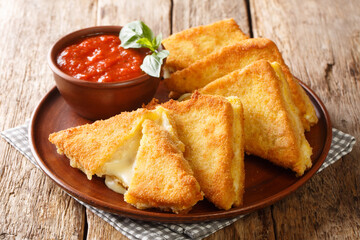 Mozzarella in Carrozza Golden Grilled Cheese Sandwiches closeup in the plate on the table....