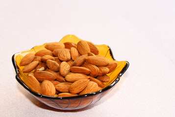 Fresh almonds in the bowl, top view 