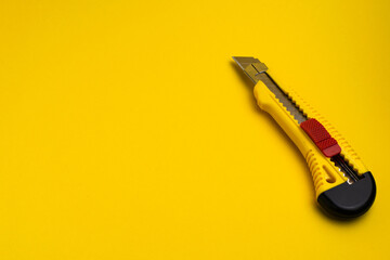 stationery knife on a yellow background