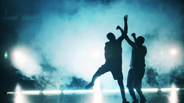 Slow motion of basketball players training in clouds of smoke