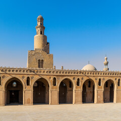 View from courtyard of Ibn Tulun Mosque with it's unique design helical outer staircase minaret, and dome and minaret of Amir Sarghatmish mosque in the far end, Sayyida Zaynab, Medieval Cairo, Egypt