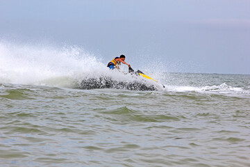 ride a hydro-scooter on the sea in the waves, outdoor activities, horizontal,..