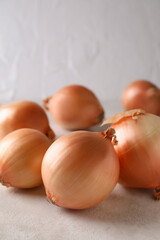 Fresh ripe onion on white textured background