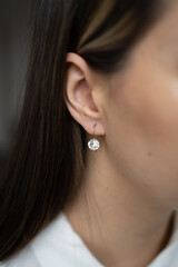 Crystal earring in female ear