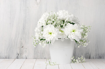 White flowers bouquet in bucket