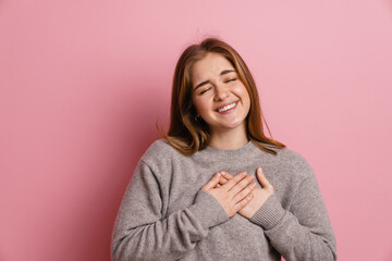 Ginger happy woman laughing while holding hands on her chest