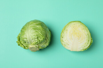Fresh green cabbage on mint background, top view