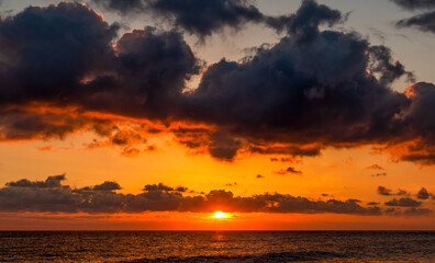 Fototapeta na wymiar Dramatic sunset over ocean. Sky with clouds.
