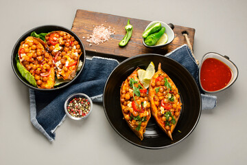 Stuffed sweet potato with spiced chickpea, dressing and herbs.