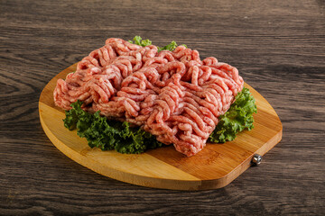 Raw pork minced meat over board