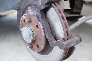 Car repair. Replacing the brake pads of disc brakes. Brake disc close-up.