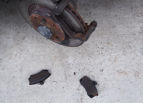 Car repair. Replacing the brake pads of disc brakes. Brake disc close-up.