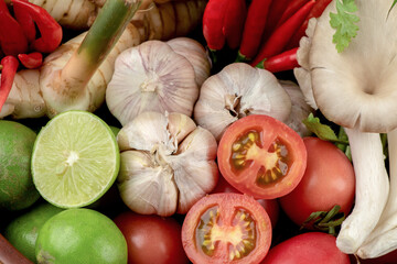 Tom yum contains chili, shallot, lemongrass, kaffir lime leaves, lemon, galangal, coriander,onion and more isolated on white background.