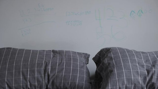 4k Panning Footage Of Kids Doodles with Marker Pen In  Parents Bedroom