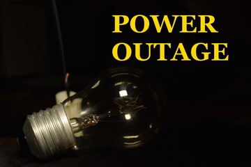 a lamp and one candle blur, with the words Power Outage writing on side.