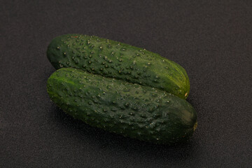 Green fresh cucumbers over background