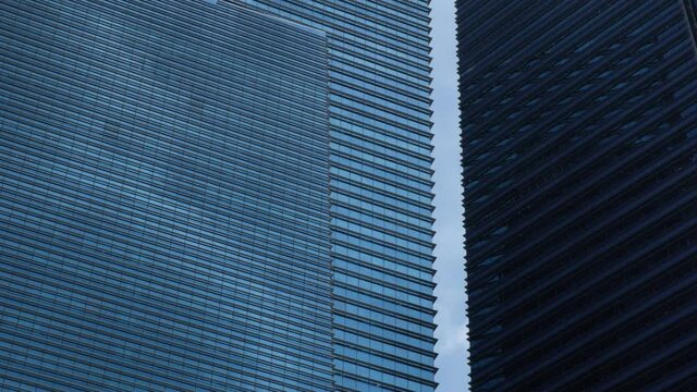 4k Footage Of A Clouds Reflected In A Full Frame, Abstract View Of A Glass And Steel Corporate Office Building.