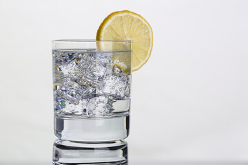 Glass with water and lemon. Lemon water for body health