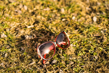 Sunglasses red model for women with a special design shoot outside in nature in a summer day . Selective focus . High quality photo