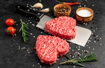 heart shaped minced meat on a knife on a stone background