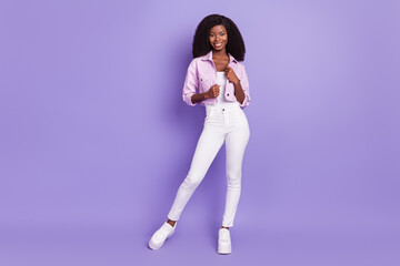 Fototapeta na wymiar Full size photo of young stunning charming smiling good mood afro girl posing isolated on violet color background