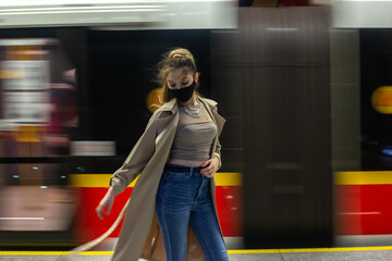 Woman in subway with protective mask